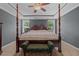 Spacious bedroom with carpet, ceiling fan, and four poster bed with bench at 45 Hawley Ridge Dr, Dunn, NC 28334