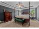 Spacious bedroom with carpet, ceiling fan, and four poster bed with green bench at 45 Hawley Ridge Dr, Dunn, NC 28334