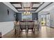Elegant dining room featuring coffered ceilings, wainscoting, wood-look flooring, and a chandelier over the table at 45 Hawley Ridge Dr, Dunn, NC 28334