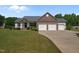 Charming single-story home boasts a three-car garage and well-manicured lawn at 45 Hawley Ridge Dr, Dunn, NC 28334