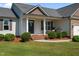 Inviting home exterior with neatly manicured lawn, complemented by lovely landscaping at 45 Hawley Ridge Dr, Dunn, NC 28334