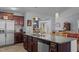 Stylish kitchen island with a stainless steel dishwasher, granite countertops, wood cabinetry, and pendant lighting at 45 Hawley Ridge Dr, Dunn, NC 28334