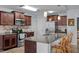 Well-equipped kitchen with stainless steel appliances, granite countertops, and rich wood cabinetry, with a view into the living area at 45 Hawley Ridge Dr, Dunn, NC 28334