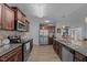 Modern kitchen featuring stainless steel appliances, granite countertops, wood cabinetry, and wood-look flooring at 45 Hawley Ridge Dr, Dunn, NC 28334