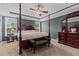 Spacious primary bedroom with four-poster bed, ceiling fan, and ample natural light at 45 Hawley Ridge Dr, Dunn, NC 28334