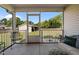 View of screened in porch with furniture overlooking large backyard and shed at 45 Hawley Ridge Dr, Dunn, NC 28334