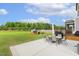 Expansive backyard with patio, outdoor dining set, and lush green lawn, perfect for outdoor activities at 4504 Beckel Rd, Willow Springs, NC 27592