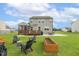Backyard with patio, deck, firepit area, and spacious lawn, perfect for outdoor entertaining at 4504 Beckel Rd, Willow Springs, NC 27592