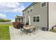 Backyard with outdoor seating area, patio, well-maintained lawn, and stylish outdoor furniture at 4504 Beckel Rd, Willow Springs, NC 27592
