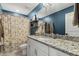 Well-lit bathroom with a granite countertop, white vanity, and a shower and tub with a floral shower curtain at 4504 Beckel Rd, Willow Springs, NC 27592