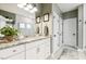 Bathroom featuring a double vanity with granite countertops, modern mirrors and a bright shower at 4504 Beckel Rd, Willow Springs, NC 27592