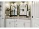 Double vanity bathroom featuring white cabinets, granite countertops, stylish mirrors, and decorative accents for a modern feel at 4504 Beckel Rd, Willow Springs, NC 27592