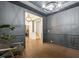 A gray dining room featuring hardwood flooring, wainscoting, and a glimpse into adjacent rooms at 4504 Beckel Rd, Willow Springs, NC 27592