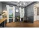 Gray dining room with wood floors, a modern chandelier, and large windows with white curtains at 4504 Beckel Rd, Willow Springs, NC 27592