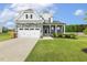 Charming two-story home with stone accents, two-car garage, and manicured lawn at 4504 Beckel Rd, Willow Springs, NC 27592