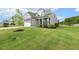 Charming two-story home with stone accents, two-car garage, and manicured lawn at 4504 Beckel Rd, Willow Springs, NC 27592