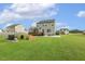 Rear exterior of a two-story house with a deck, patio, and well-manicured backyard with a play area at 4504 Beckel Rd, Willow Springs, NC 27592