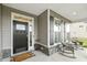Inviting covered front porch with rocking chairs and a stylish front door at 4504 Beckel Rd, Willow Springs, NC 27592