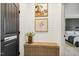 Hallway featuring wainscoting, rustic wooden bench, and playful dog-and-baby photography at 4504 Beckel Rd, Willow Springs, NC 27592