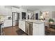 Bright kitchen with white cabinetry, stainless steel appliances, granite counters, and dark hardwood floors at 4504 Beckel Rd, Willow Springs, NC 27592