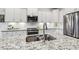 A kitchen featuring white cabinets, granite countertops, stainless steel appliances, and tiled backsplash at 4504 Beckel Rd, Willow Springs, NC 27592