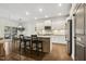 Bright kitchen with white cabinetry, stainless steel appliances, and a granite island with seating at 4504 Beckel Rd, Willow Springs, NC 27592