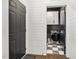 The laundry room with shiplap walls features a modern washer and dryer, upper cabinets, and stylish checkerboard flooring at 4504 Beckel Rd, Willow Springs, NC 27592