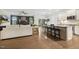 Open concept living area with kitchen island and white cabinets, a fireplace, and neutral-toned furnishings at 4504 Beckel Rd, Willow Springs, NC 27592