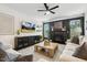 Bright living room with a fireplace, comfortable seating, and a ceiling fan at 4504 Beckel Rd, Willow Springs, NC 27592