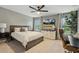 This main bedroom features a ceiling fan, TV, and large window allowing for lots of natural light and views at 4504 Beckel Rd, Willow Springs, NC 27592