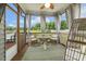 Cozy screened-in porch featuring stylish seating and a charming ceiling fan for relaxed outdoor living at 4504 Beckel Rd, Willow Springs, NC 27592