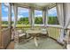 Outdoor screened porch with patio seating, a ceiling fan, and a view of the yard at 4504 Beckel Rd, Willow Springs, NC 27592
