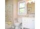 Well-lit bathroom with white vanity, marble tile, and a window for natural light at 5013 Brassfield Dr, Rocky Mount, NC 27803