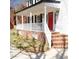 Inviting front porch featuring brick accents, a vibrant red door, and fresh landscaping, for a welcoming entrance at 5013 Brassfield Dr, Rocky Mount, NC 27803