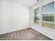 An empty bedroom features neutral carpet, white walls, a window and mini blinds at 51 Duchess Ave, Franklinton, NC 27525