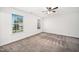 A spacious bedroom with carpet flooring, ceiling fan, and two large windows for natural light at 51 Duchess Ave, Franklinton, NC 27525