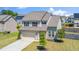 Two-story home featuring a two-car garage, a manicured lawn, and mature trees at 51 Duchess Ave, Franklinton, NC 27525
