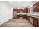 A new kitchen features stainless steel appliances, wood cabinets, and laminate flooring at 51 Duchess Ave, Franklinton, NC 27525