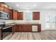 Kitchen features stainless steel appliances, dark wood cabinets, and granite countertops at 51 Duchess Ave, Franklinton, NC 27525