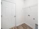 Bright laundry room featuring tile floors, wire shelving, and a door to outside at 51 Duchess Ave, Franklinton, NC 27525