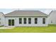 Back of the house featuring siding, a gray roof, and large windows overlooking a lawn at 529 Winding Creek Drive Dr, Lillington, NC 27546