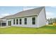 View of the backyard and siding, with sliding glass doors and four large windows at 529 Winding Creek Drive Dr, Lillington, NC 27546