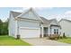 Beautiful home featuring light blue siding, a brick foundation, and an attached two-car garage at 529 Winding Creek Drive Dr, Lillington, NC 27546