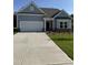 Charming single-story home with a two-car garage, manicured lawn, and inviting front porch at 529 Winding Creek Drive Dr, Lillington, NC 27546