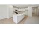 Bright, all-white kitchen featuring an island, stainless appliances, and lots of cabinet space at 529 Winding Creek Drive Dr, Lillington, NC 27546
