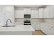 Modern kitchen featuring an island, stainless appliances, quartz countertops, and white cabinets at 529 Winding Creek Drive Dr, Lillington, NC 27546