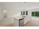 Bright open concept with modern kitchen island, stainless dishwasher, and view to the living space at 529 Winding Creek Drive Dr, Lillington, NC 27546