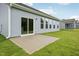 Backyard patio of the home featuring sliding glass doors and a well-maintained lawn at 529 Winding Creek Drive Dr, Lillington, NC 27546