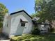 Quaint white home featuring horizontal siding, contrasted by dark trim and a well-manicured lawn at 541 N Daughtry St, Rocky Mount, NC 27801