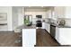 Bright kitchen featuring white cabinets, stainless steel appliances, and a granite countertop island at 58 Butterbean Ct, Zebulon, NC 27597
